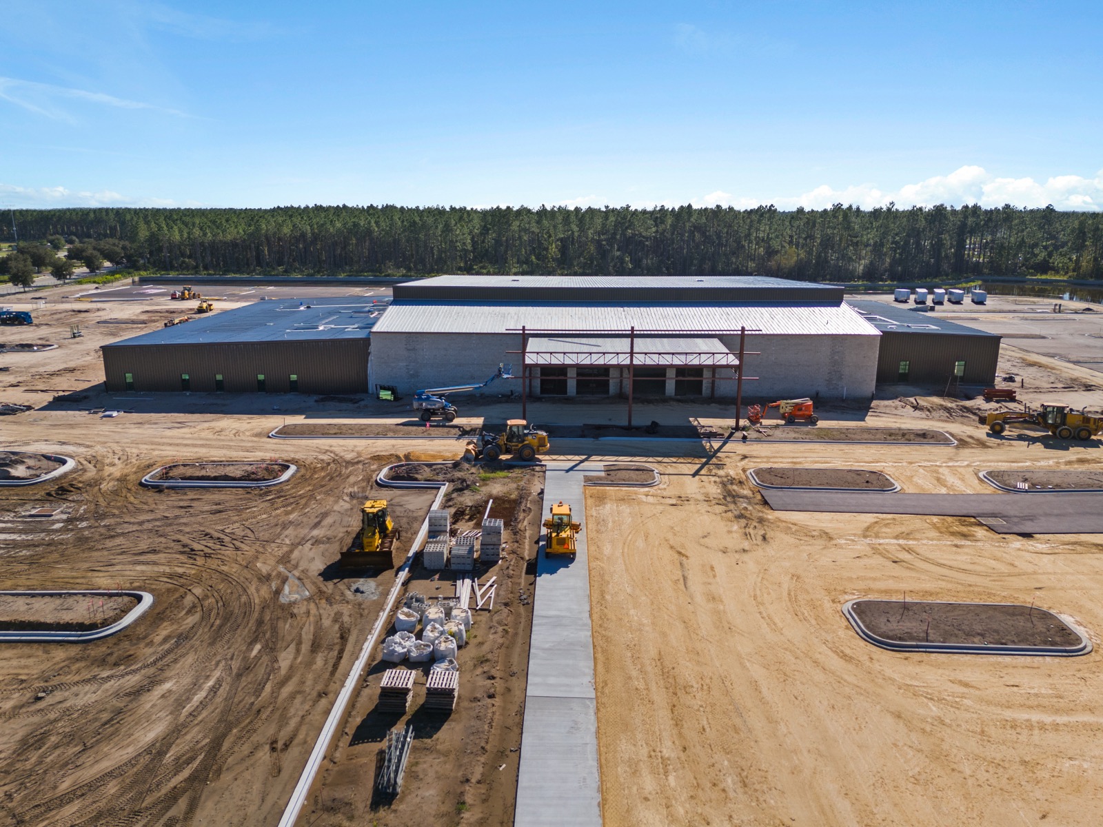 Aerial view of a church building under construction, site work underway